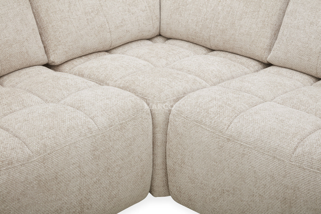 Close-up of a beige fabric sectional sofa