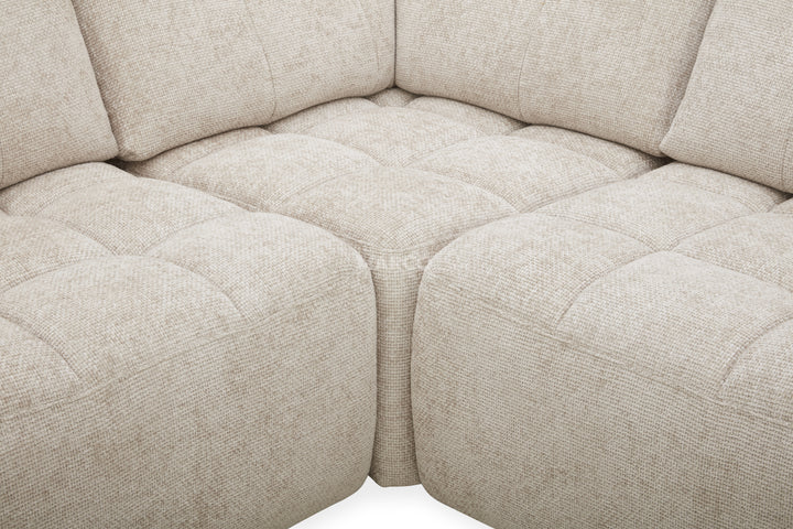 Close-up of a beige fabric sectional sofa