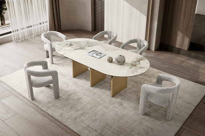 Modern dining room with a round table and chairs on a light rug.