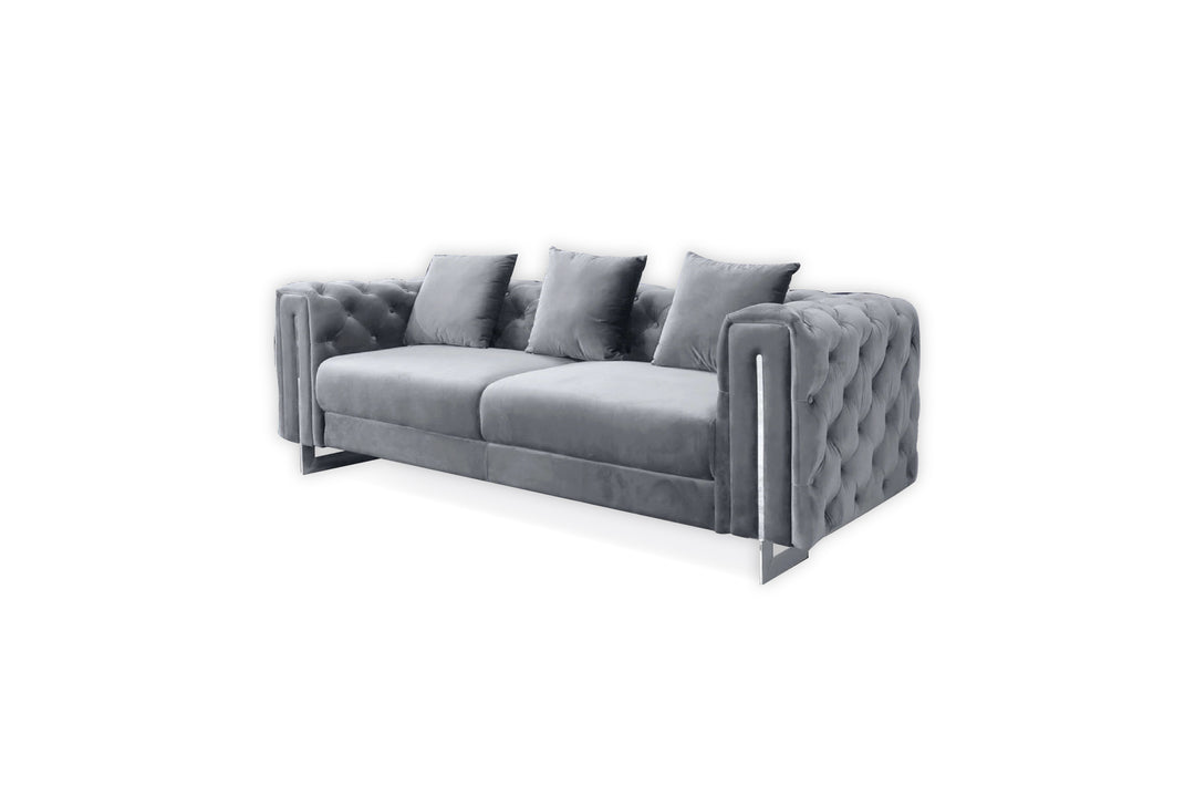Gray tufted sofa with three cushions on a white background