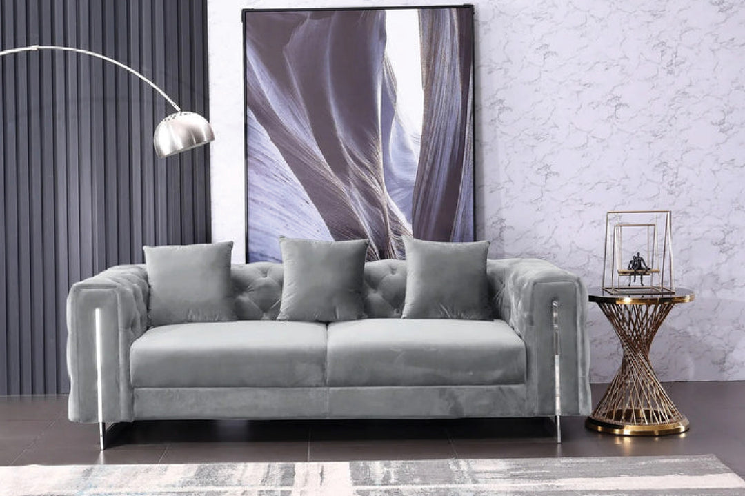 Gray sofa in a room with a large abstract painting on the wall.