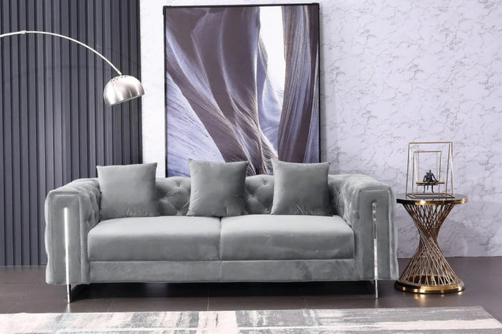 Gray sofa in a room with a large abstract painting on the wall.