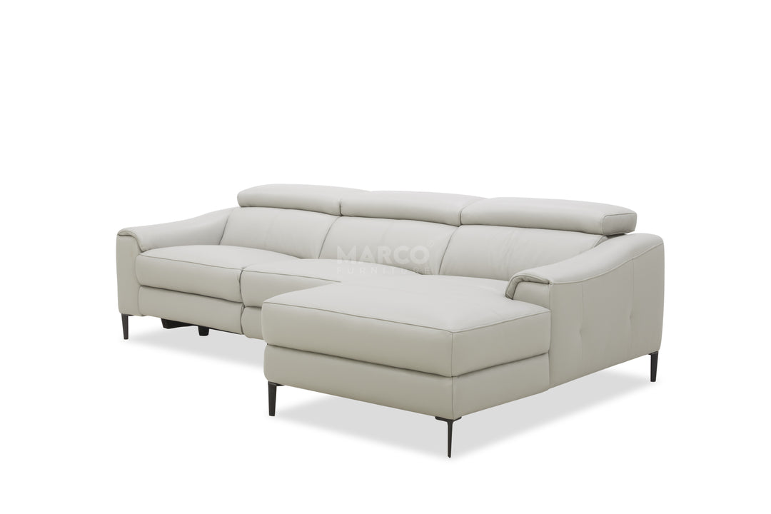 Light gray sectional sofa with ottoman on a white background