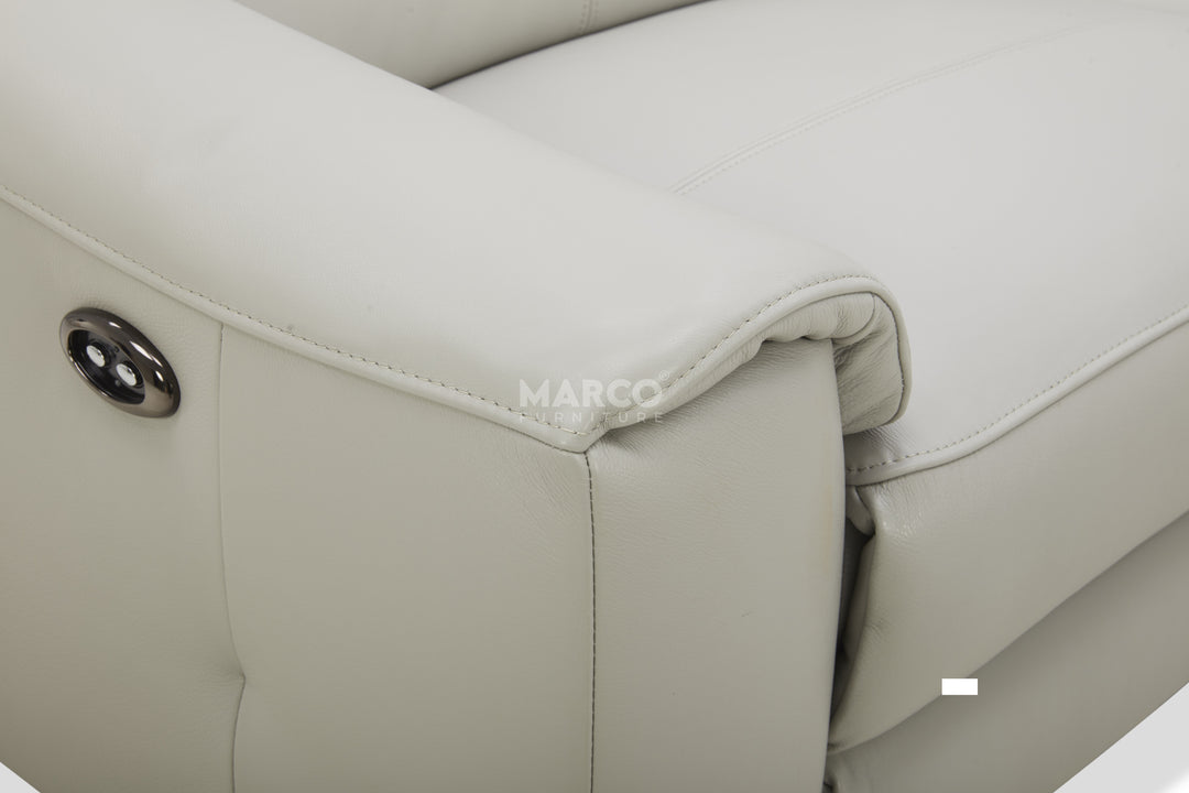 Close-up of a beige leather seat with 'MARCO' branding.