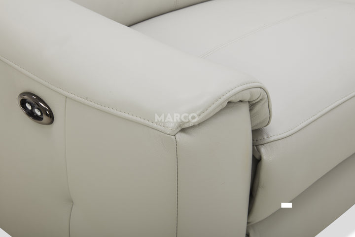 Close-up of a beige leather seat with 'MARCO' branding.