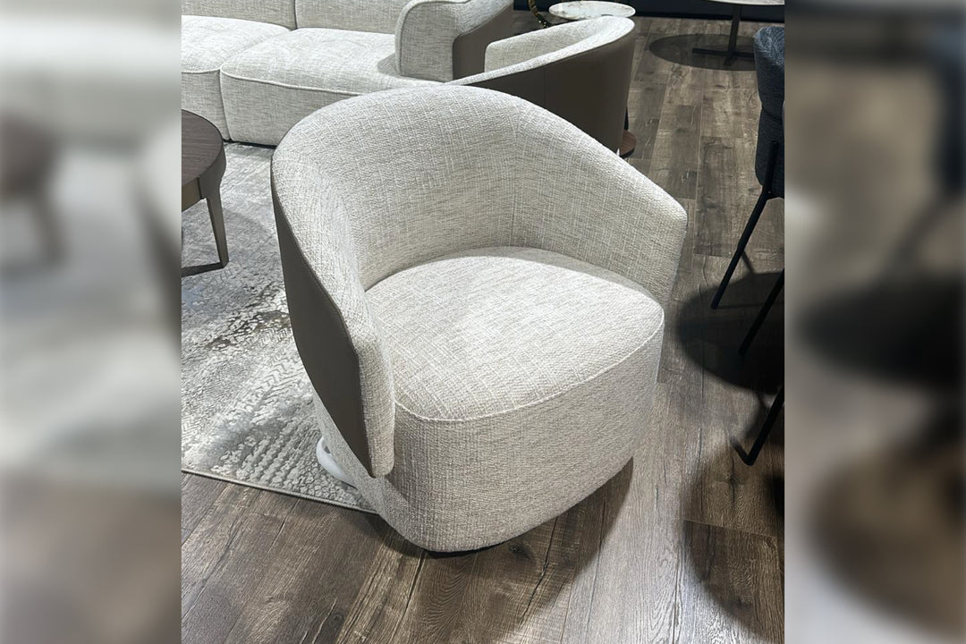 Gray upholstered chair on a wooden floor with blurred edges
