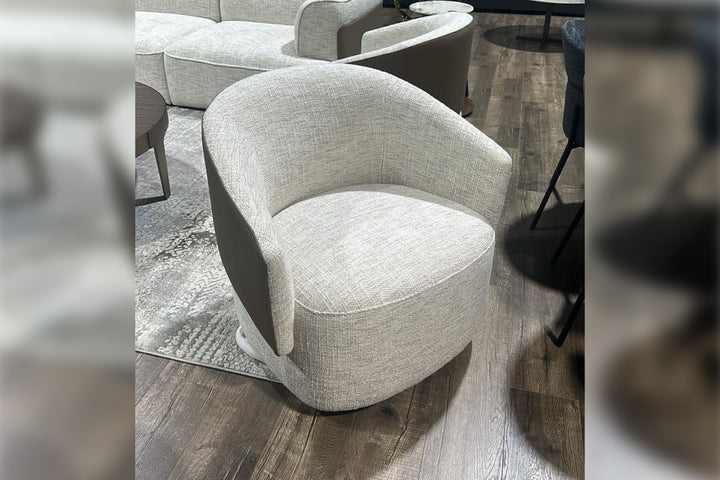 Gray upholstered chair on a wooden floor with blurred edges