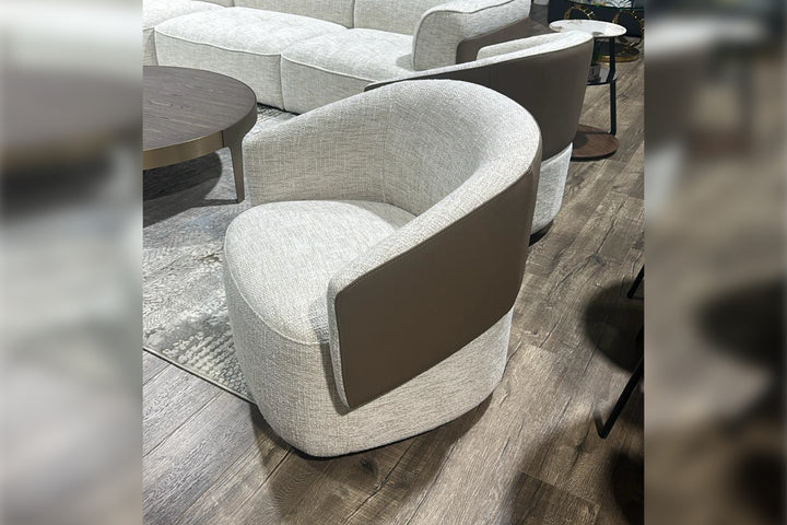 Modern gray armchair in a living room setting with a wooden floor.