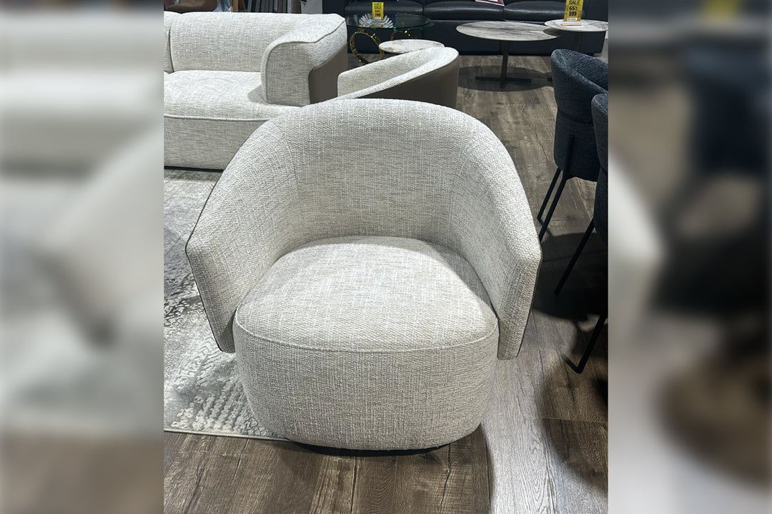 Gray textured armchair in a room with other furniture.