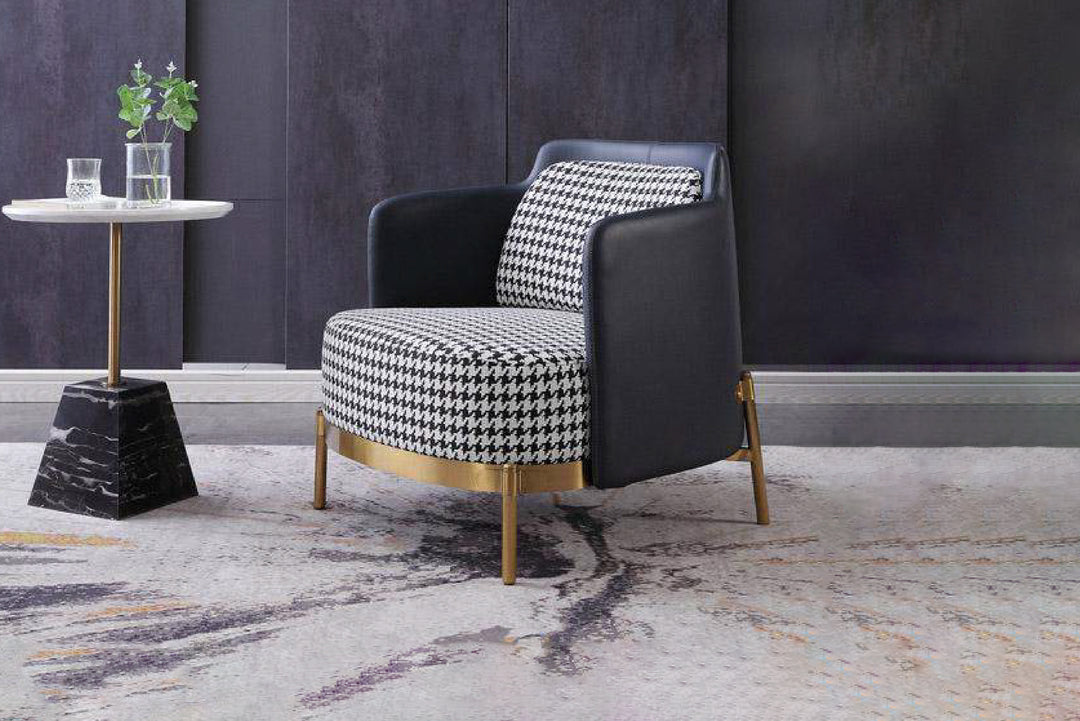 Modern armchair with houndstooth pattern in a stylish room with a side table and plant.