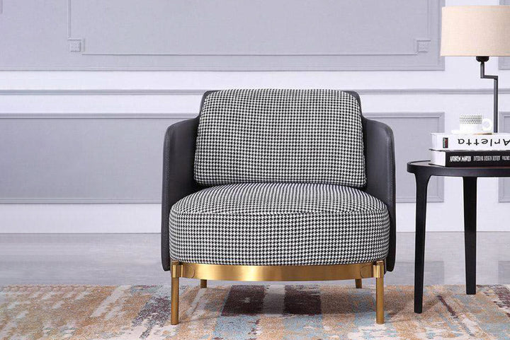 Patterned armchair with gold base in a room setting