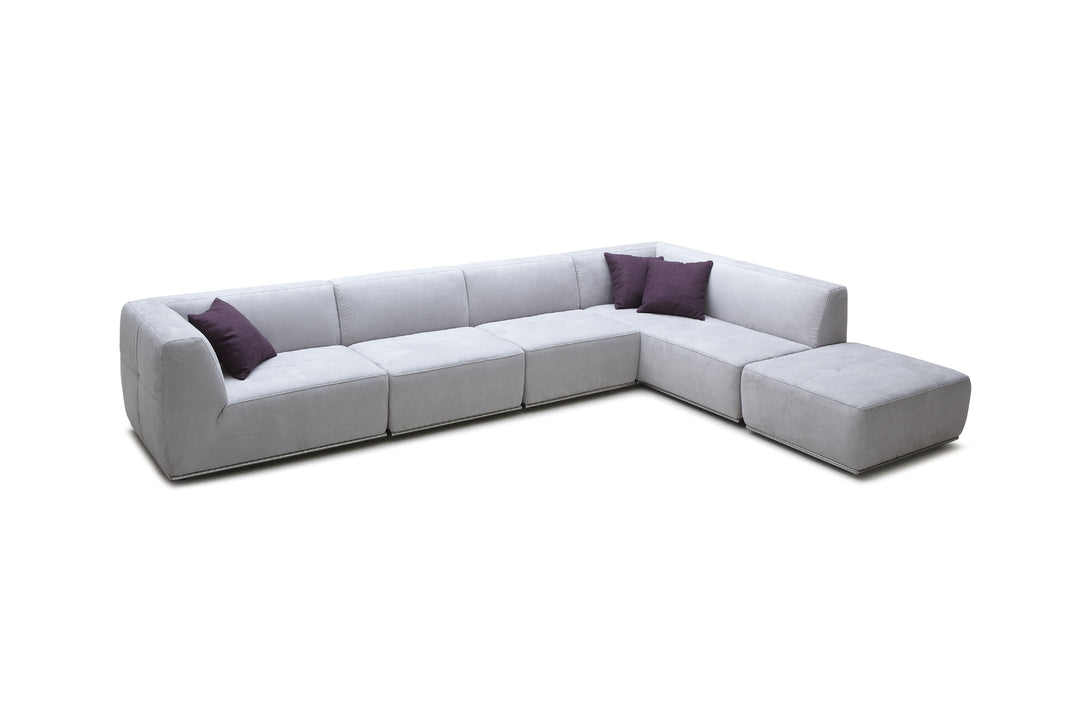 Gray sectional sofa with purple cushions on a white background