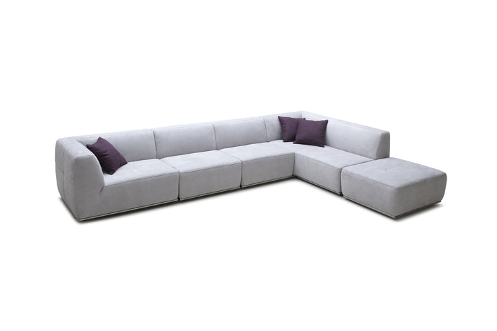 Gray sectional sofa with purple cushions on a white background