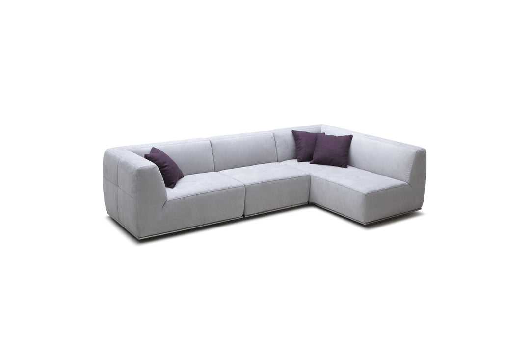 Gray sectional sofa with purple cushions on a white background