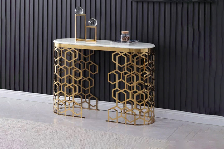 Decorative console table with gold geometric design against a dark paneled wall.