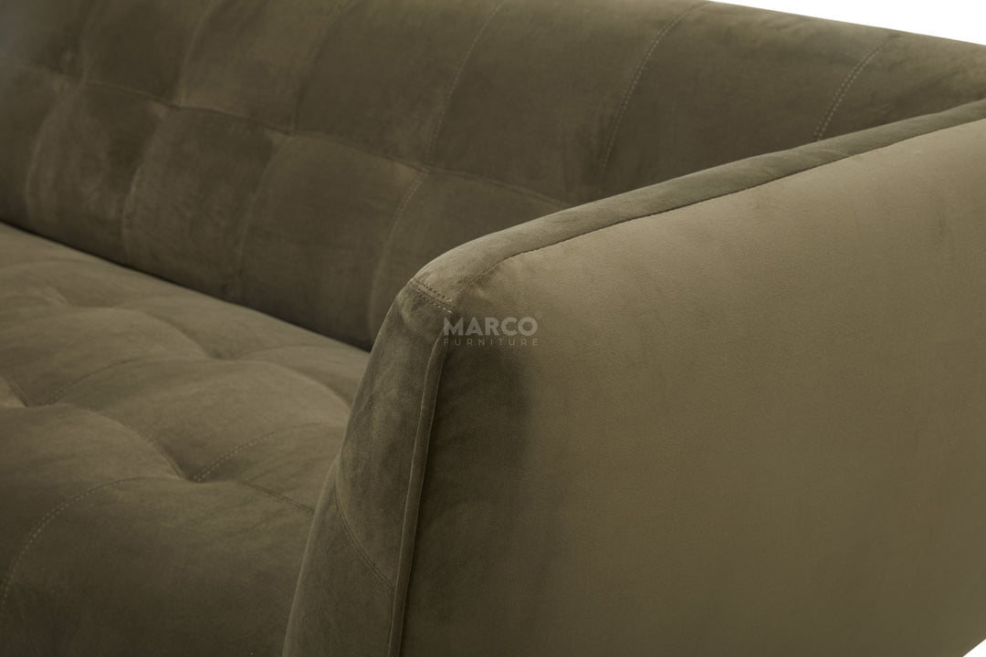 Close-up of a brown upholstered sofa with tufted design