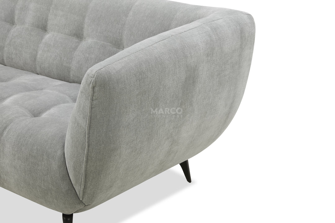 Gray sofa with tufted design on a white background, featuring the brand 'MARCO'.