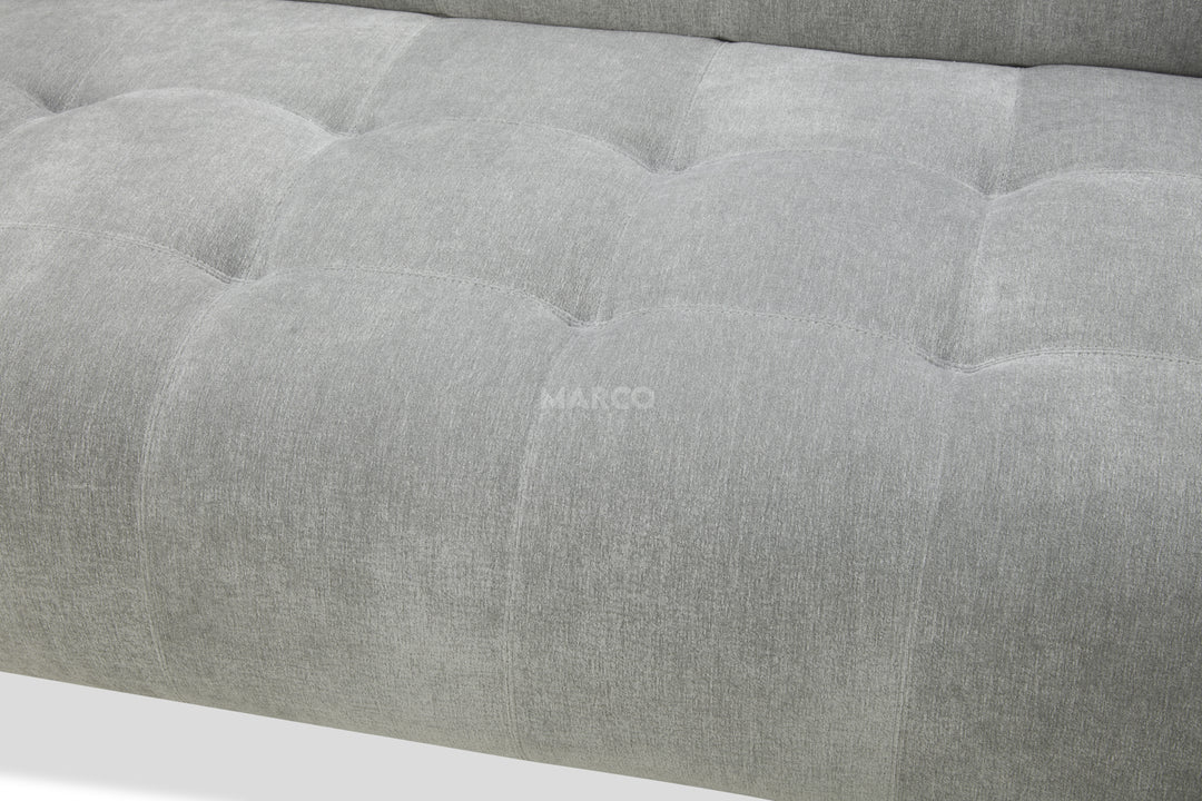 Gray upholstered headboard with tufted design and 'MARCO' branding.