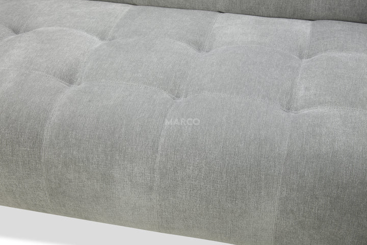 Gray upholstered headboard with tufted design and 'MARCO' branding.