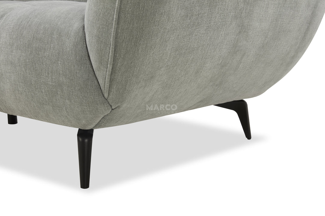 Gray upholstered chair with black legs on a white background, featuring the brand 'Marco'.