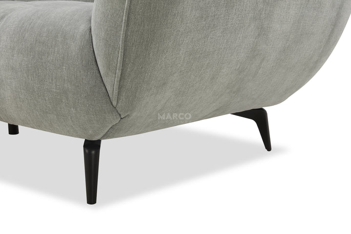 Gray upholstered chair with black legs on a white background, featuring the brand 'Marco'.