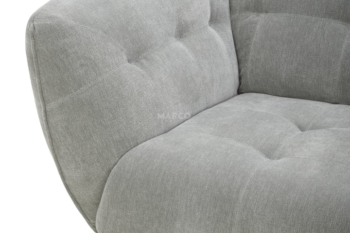 Gray upholstered chair with tufted design on a white background