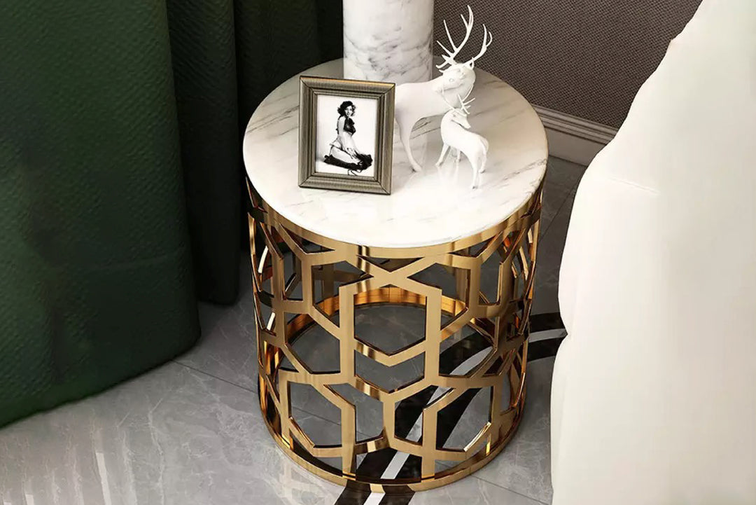 Decorative side table with gold geometric design and marble top