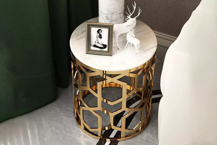 Decorative side table with gold geometric design and marble top