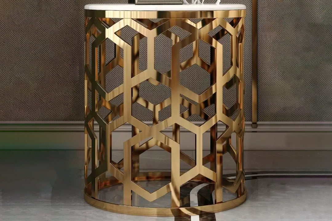 Decorative gold side table with geometric pattern against a neutral background