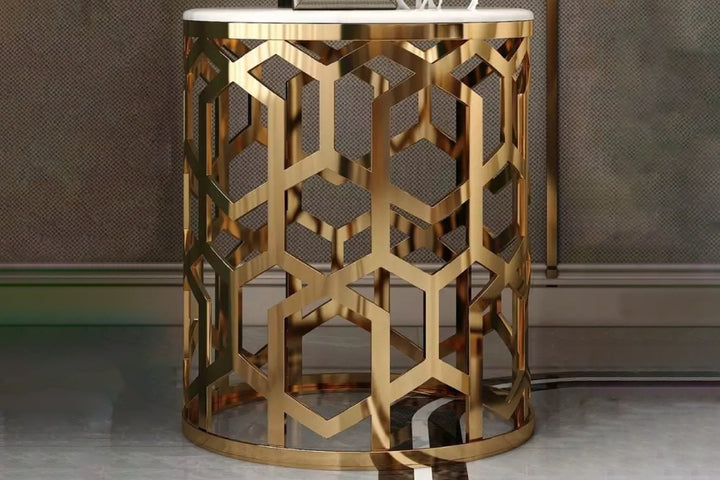 Decorative gold side table with geometric pattern against a neutral background