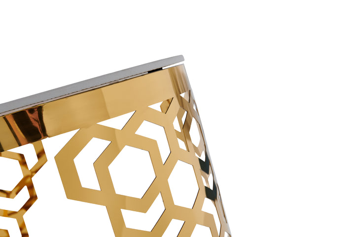 Gold metal stool with geometric cutout design on a white background