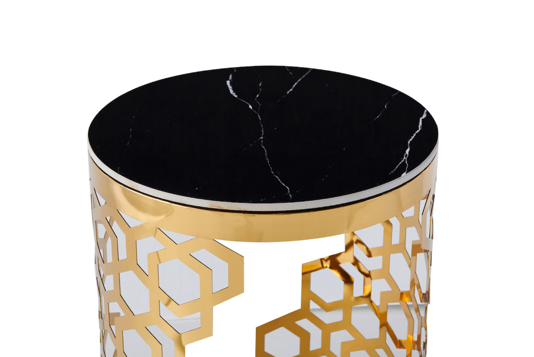 Decorative side table with black marble top and gold geometric pattern on base