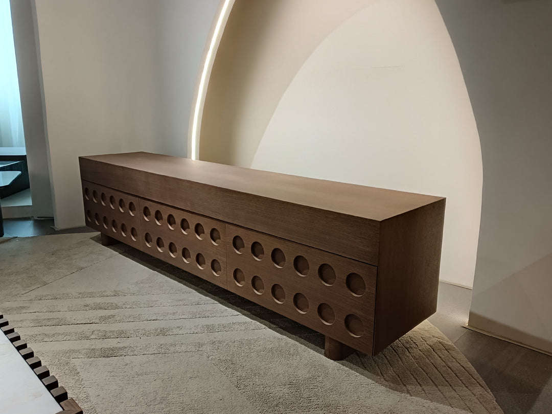 Wooden bench with circular cutouts in a minimalistic setting