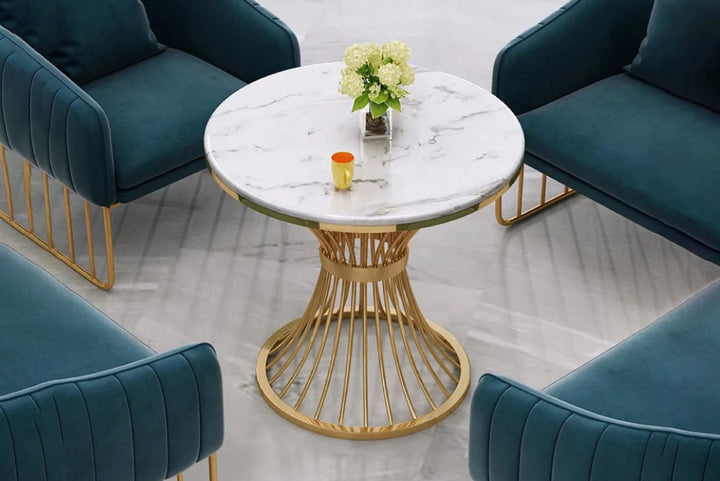 Teal velvet chairs around a marble-top coffee table with gold base