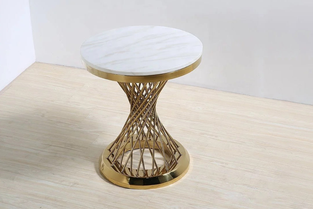 Decorative stool with marble top and gold metal base on a wooden surface.