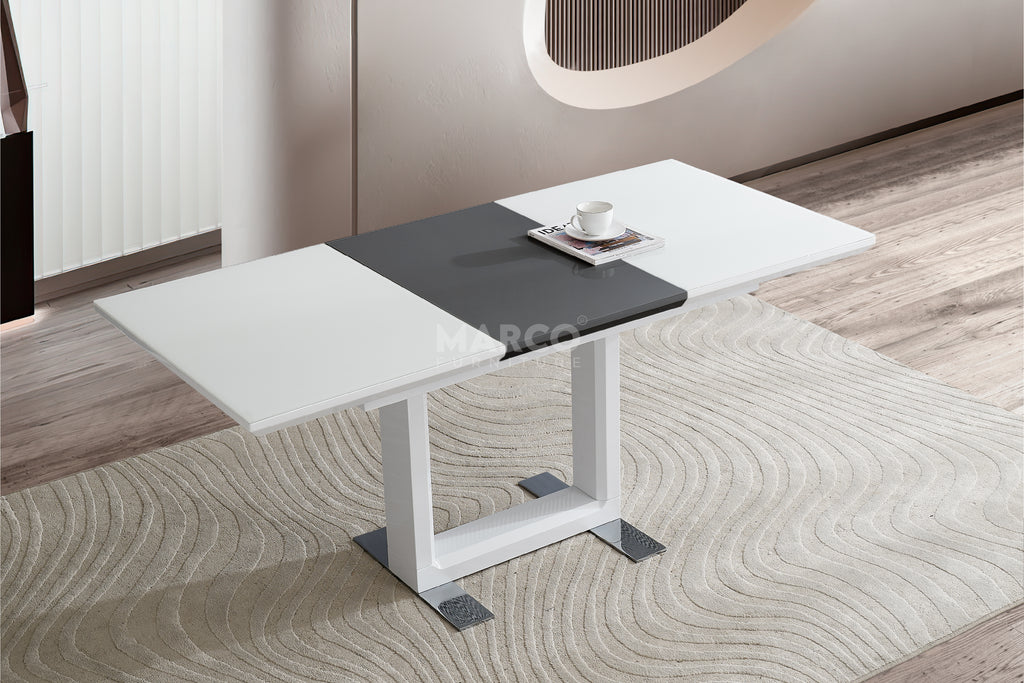 Modern glass dining table with black and white design in a room.