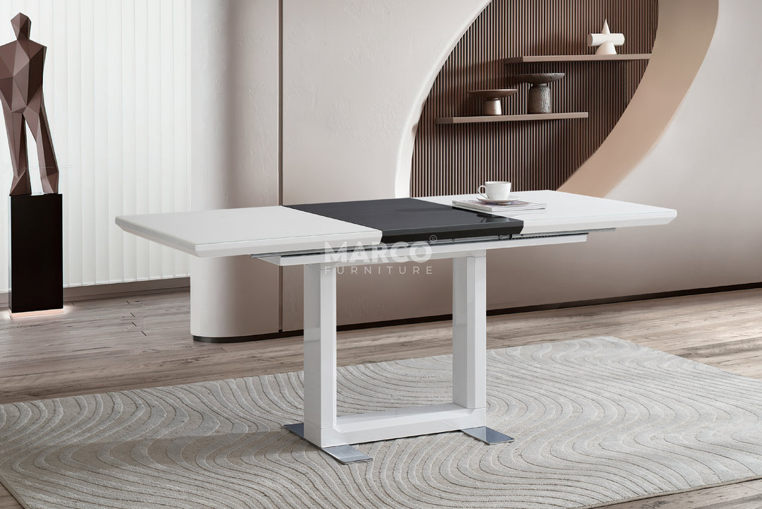 Modern white dining table in a stylish room with a rug and shelves.