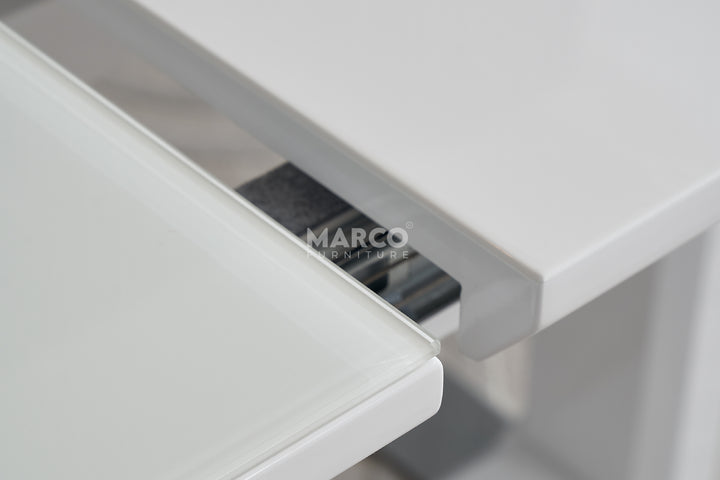 Close-up of a white drawer with a metallic handle.