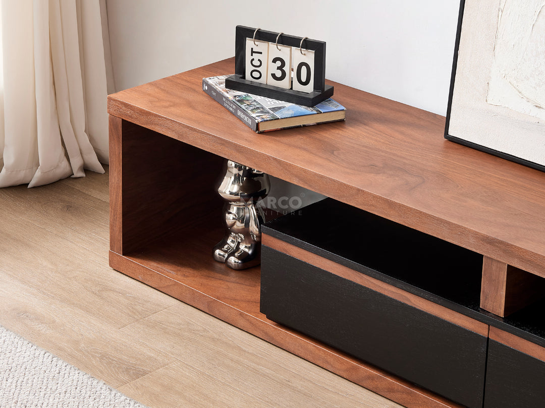 Wooden TV stand with shelf and decorative items in a living room.