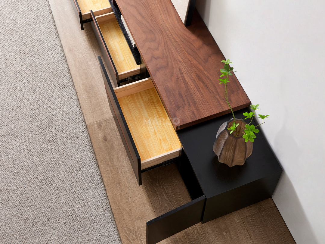 Modern kitchen cabinet with open drawers and a potted plant on a black tray.