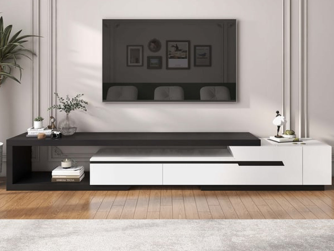 Modern black and white entertainment console with TV above in a living room setting.