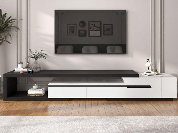 Modern black and white entertainment console with TV above in a living room setting.