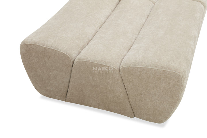 Beige fabric ottoman with 'MARCO' branding on a white background