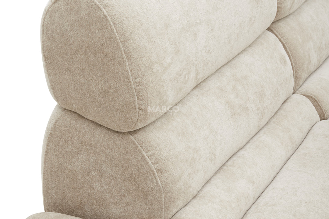 Close-up of a beige upholstered chair with 'Marco' branding.