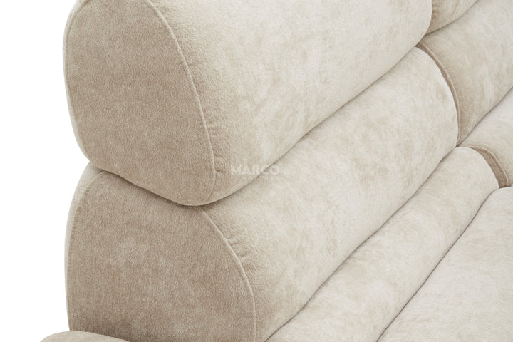 Close-up of a beige upholstered chair with 'Marco' branding.