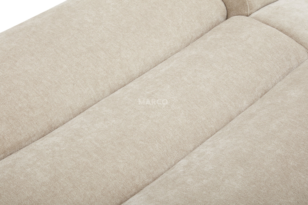 Close-up of a beige fabric sofa with 'HARCO' branding.