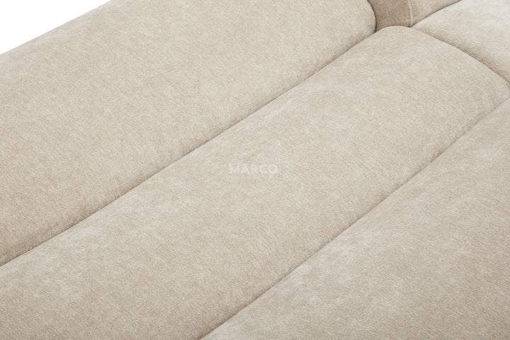 Close-up of a beige fabric sofa with 'HARCO' branding.