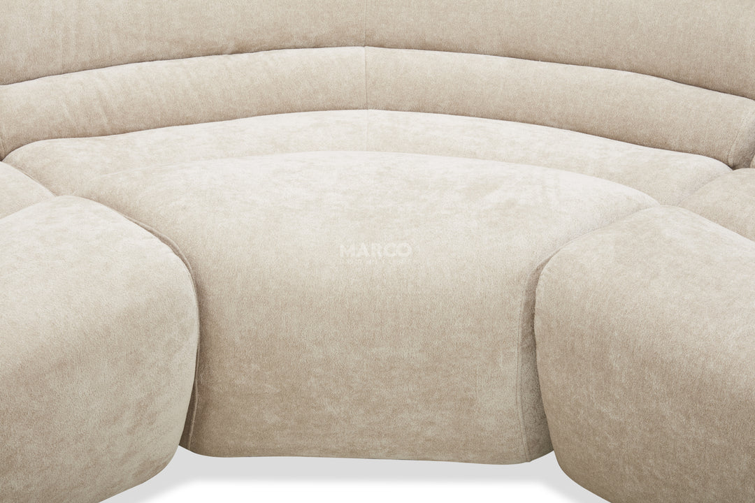 Close-up of a beige sofa with 'Herman Miller' branding.