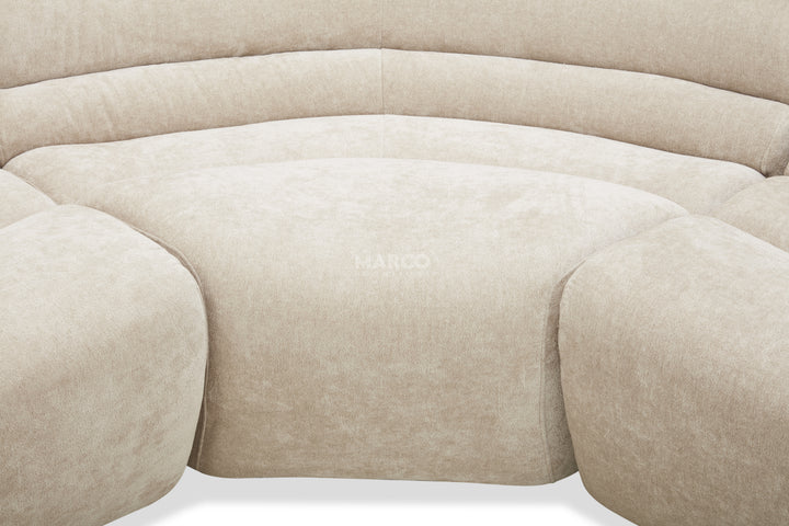 Close-up of a beige sofa with 'Herman Miller' branding.