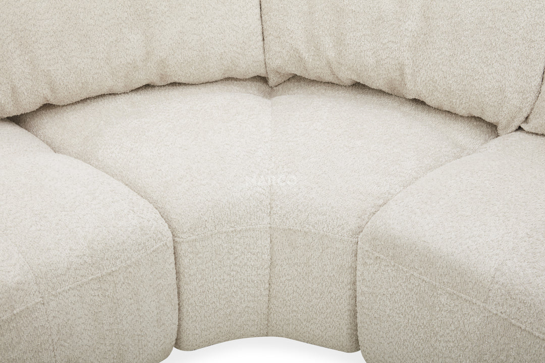 Close-up of a beige upholstered chair with a textured fabric surface.